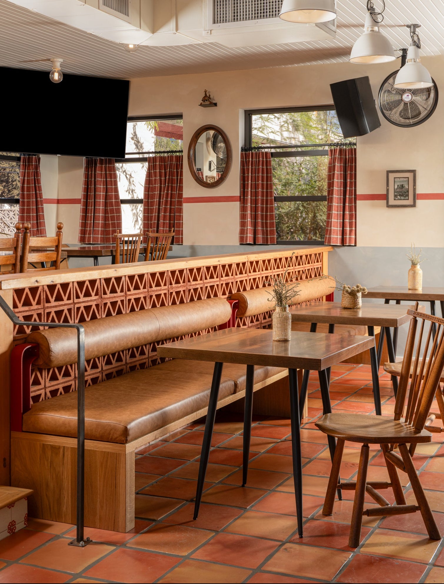Reddish-brown clay Triangle Breeze Block from Clay Imports Breeze Blocks forming a geometric partition in a restaurant.