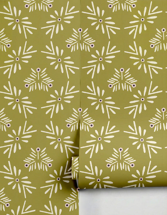 Olive green Margarita Wallpaper by Clay Imports, featuring a repeating creamy white abstract floral pattern with dark purple centers, partially unrolled.