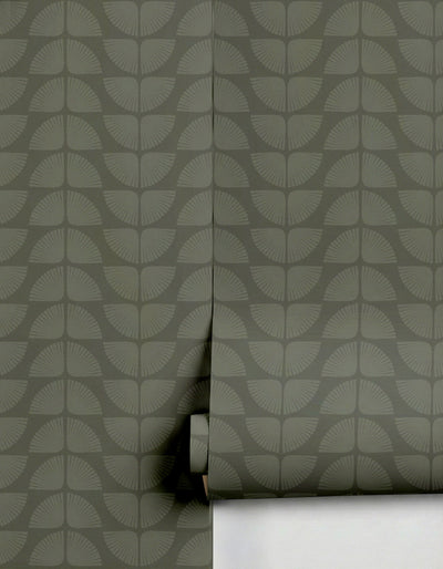 Dark green Petalita Wallpaper by Clay Imports, featuring a subtle fan-like pattern, partially unrolled.