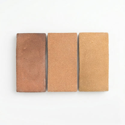 Three rectangular Ember Cotto samples from Clay Imports in varying brown shades with a coarse matte texture, displayed side-by-side.