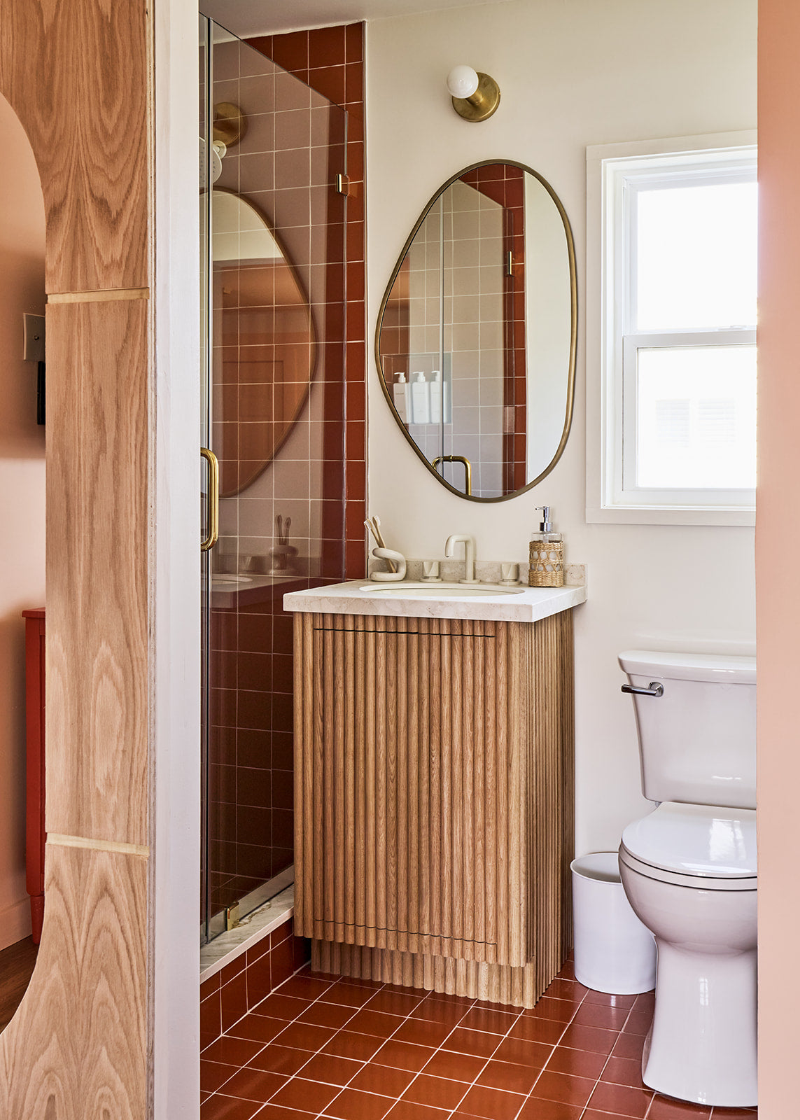 Whiskey solid tile by Clay Imports in a square pattern on a bathroom floor and shower walls.