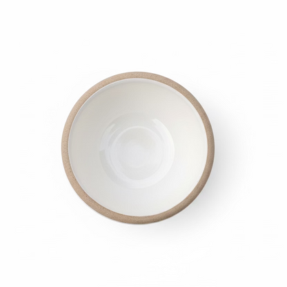 White gloss tea cup with an exposed textured clay rim by Clay Imports, viewed from above.