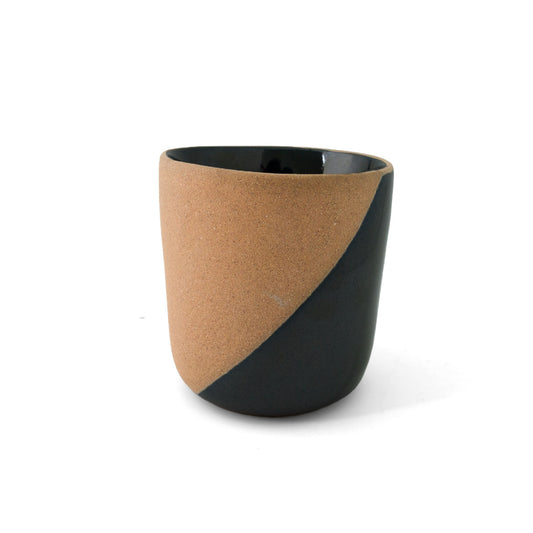 Two-toned clay copita by Clay Imports, with a textured natural tan body and smooth black diagonal design.