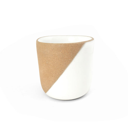 A two-tone clay copita by Clay Imports, featuring a diagonal design of textured light brown and smooth white.