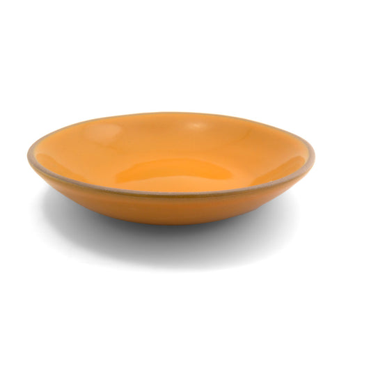 Shallow orange entree bowl by Clay Imports, with a natural clay rim, casting a shadow.
