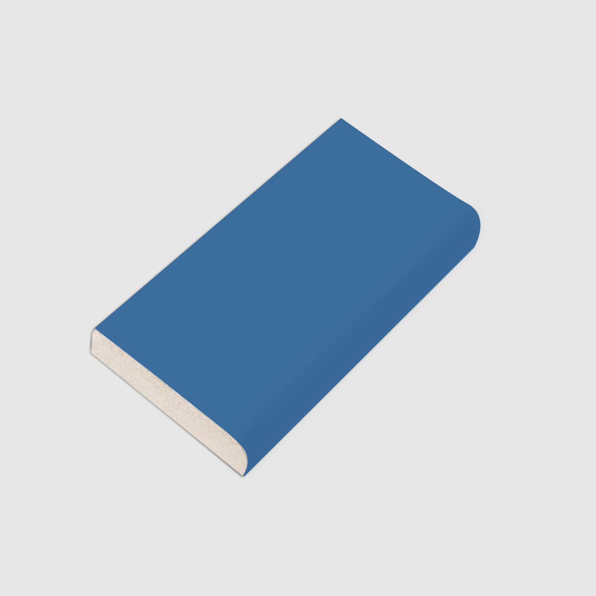 A blue glossy bullnose tile by Clay Imports, showing its rounded edge and light-colored core.